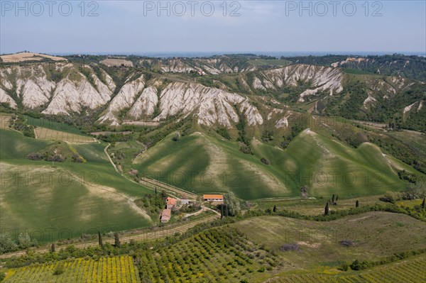 Aerial view of a hilly landscape with erosion valleys