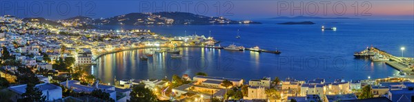 Panorama of Mykonos town Greek tourist holiday vacation destination with famous windmills