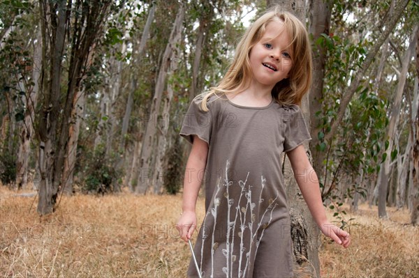 Young girl playing in the woods