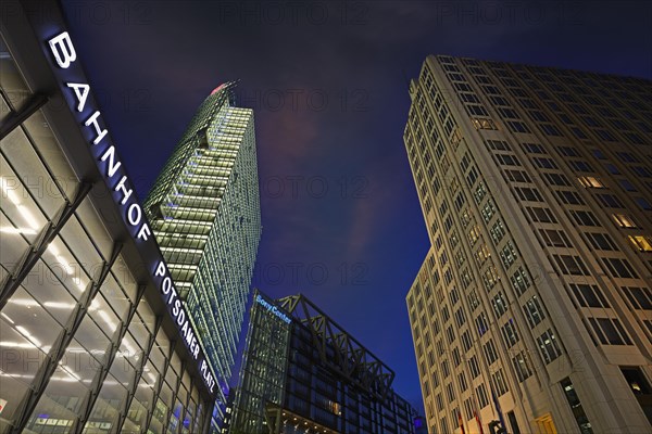 Station entrance Potsdamer Platz and Bahntower on the left and Beisheim-Center with Ritz Carlton Hotel on the right in the evening at Potsdamer Platz