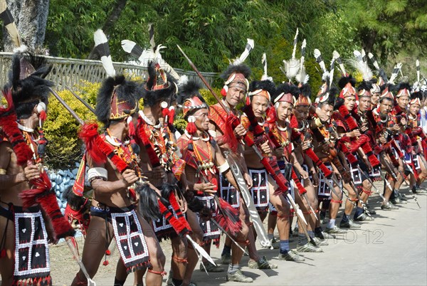 Performers from a Naga tribal group line up to greet officials at the Hornbill Festival