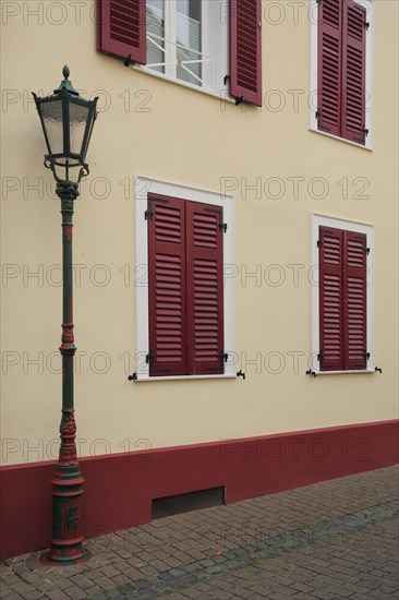 Street lamp with neoclassical house wall with shutters from Maximilians restaurant built in 1854 in Bad Soden