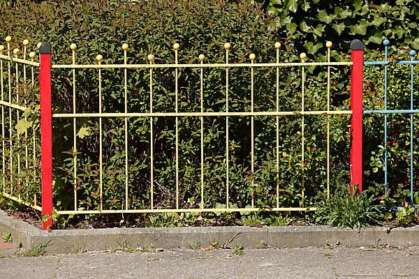 Old decorated colourful garden fence