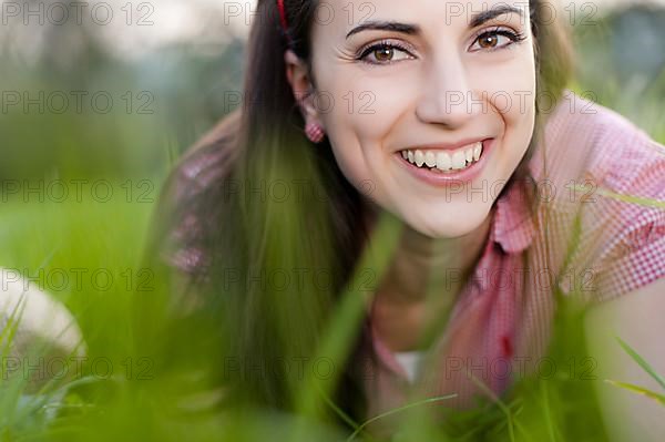 Young woman lying in meadow,