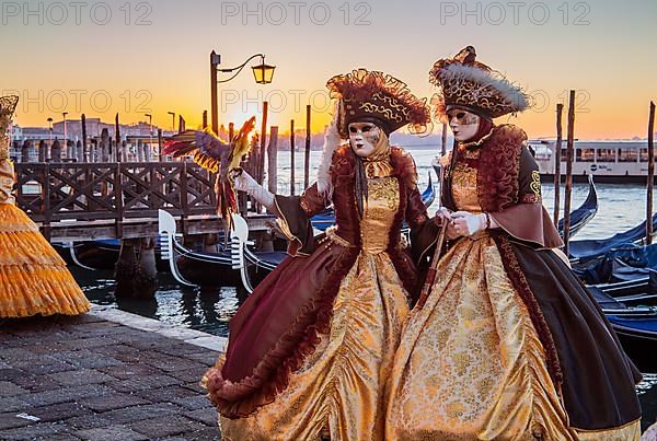 Carnival masks on the waterfront at sunrise, Venice