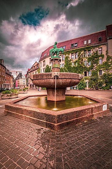 Long exposure of the donkey fountain in the city centre of Halle-Saale under dense rain clouds, Halle Saale