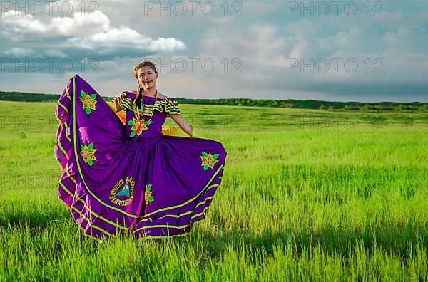 Nicaraguan woman in traditional folk costume in the field grass, Portrait of Nicaraguan woman wearing national folk costume