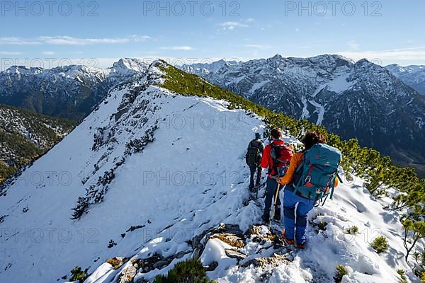 Hikers on a ridge in autumn with snow, hiking trail to Weitalpspitz