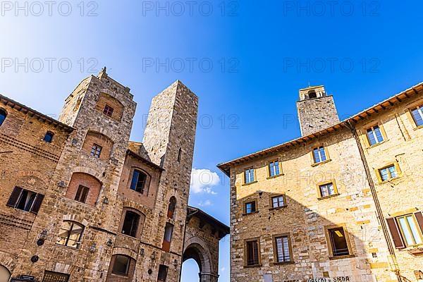 Gender towers and medieval buildings against a blue sky, San Gimignano