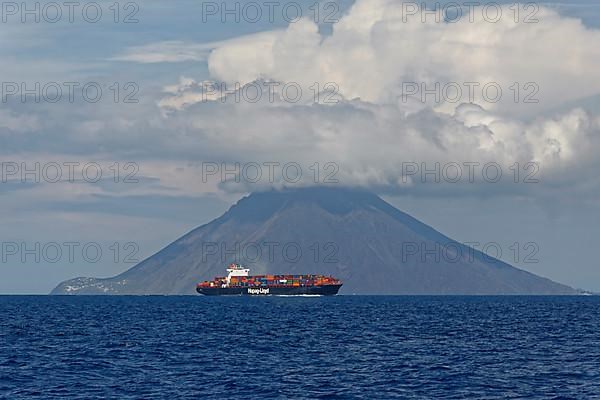 Container ship in front of Stromboli volcano and island