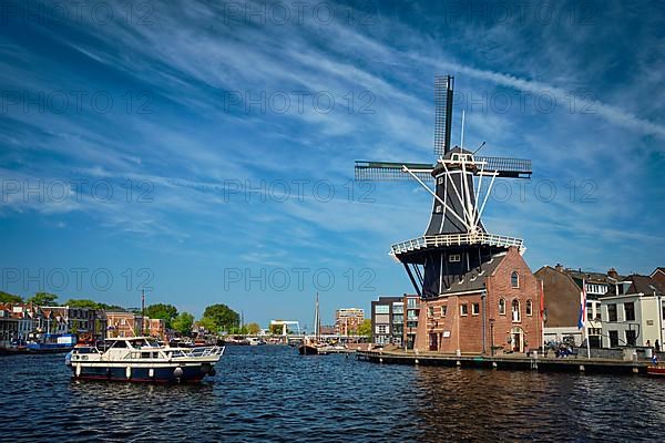 View of Harlem landmark windmill De Adriaan on Spaarne river. Harlem