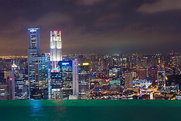 The city's central financial district at night as seen from the infinity pool of the Marina Bay Sands Hotel