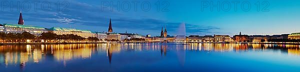 Inner Alster with Alsterfontaine and city skyline in the evening