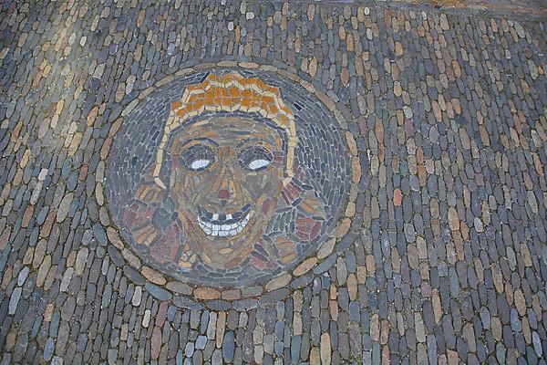 Round floor mosaic for Halloween with head and face made of colourful stones in Freiburg