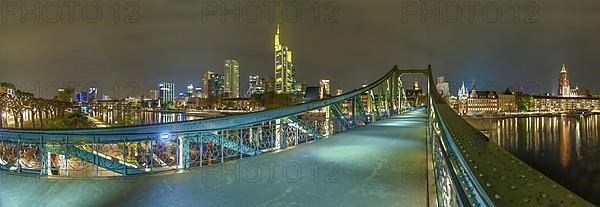 Frankfurt by night at the iron bridge with skyline panorama Germany
