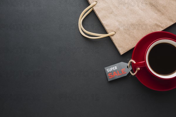 Discount paper bag with coffee flat lay