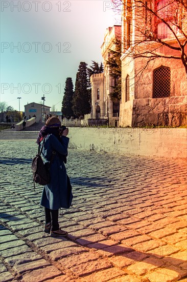 Tourist girl photographer with dslr camera outdoor in city street