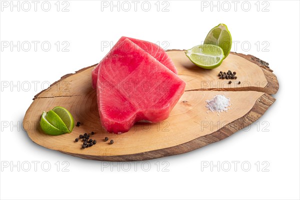 Fresh raw tuna steak on wooden cutting board