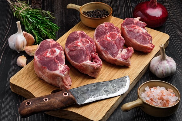 Chopped fresh lamb shank steak with spice on cutting board with spice