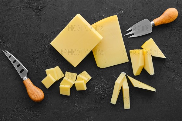 Top view of two kind of semi-soft cheese on dark wooden background