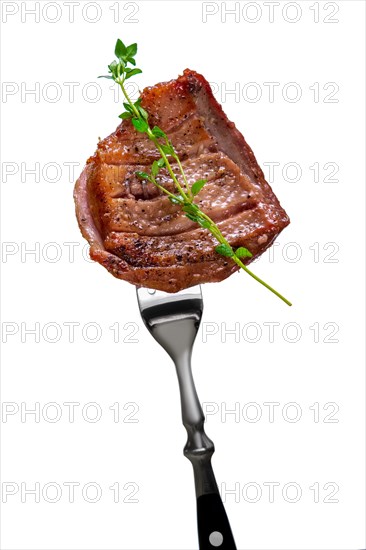 Piece of fried meat on fork isolated on white