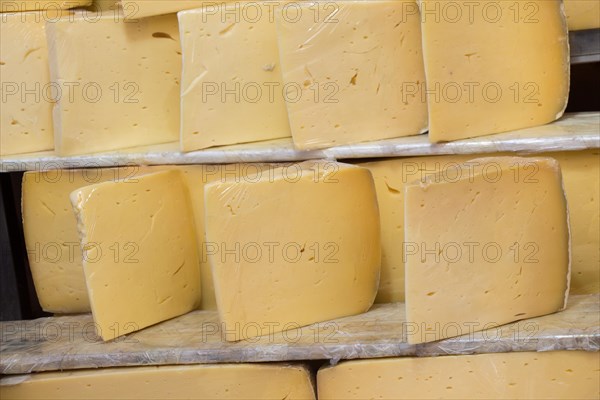 Cuts of kashkaval or kasseri cheese for sale on the shelf