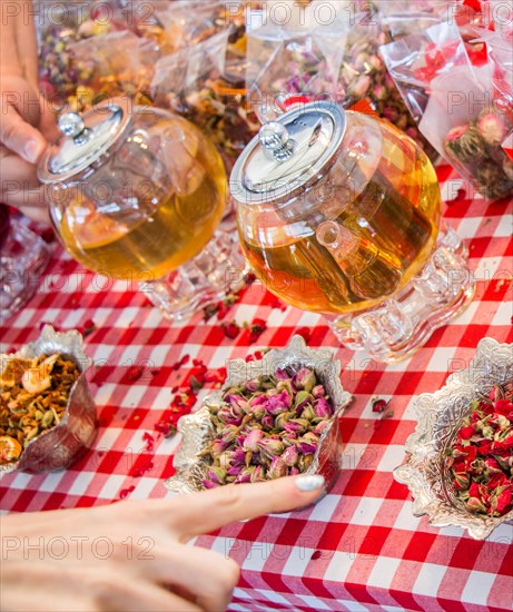 Herbal tea in glass teapot on table