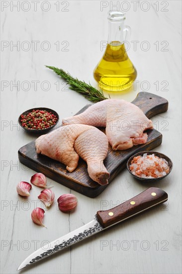 Raw chicken thighs on wooden cutting board ready for cooking