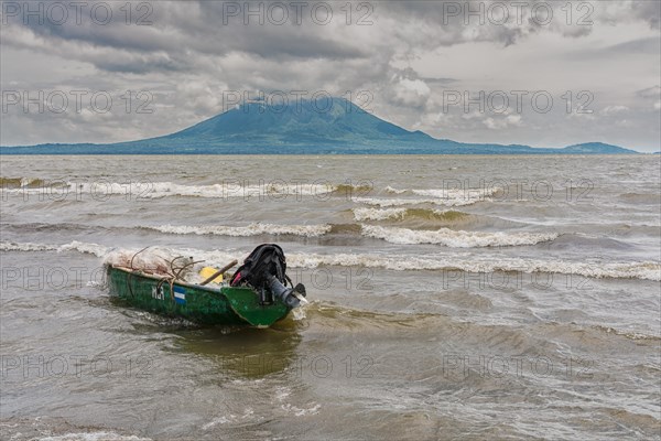 A wooden fishing boat on the shore of a lake