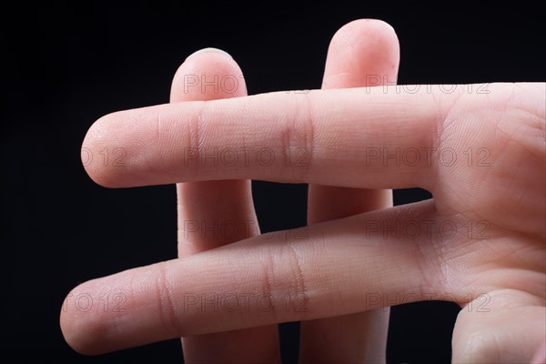 Fingers forming a hashtag symbol isolated on black background