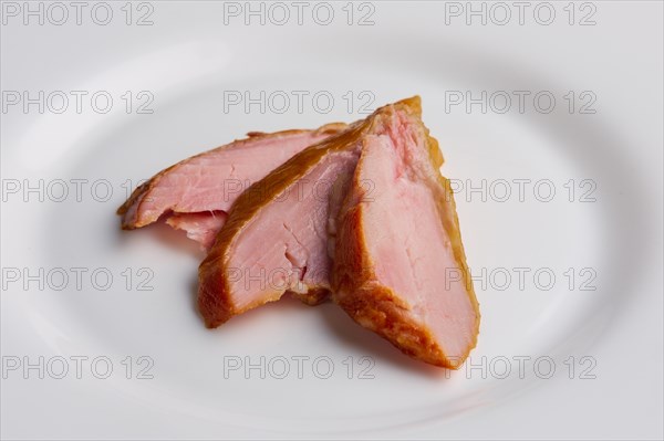 Three slices of ham on a plate