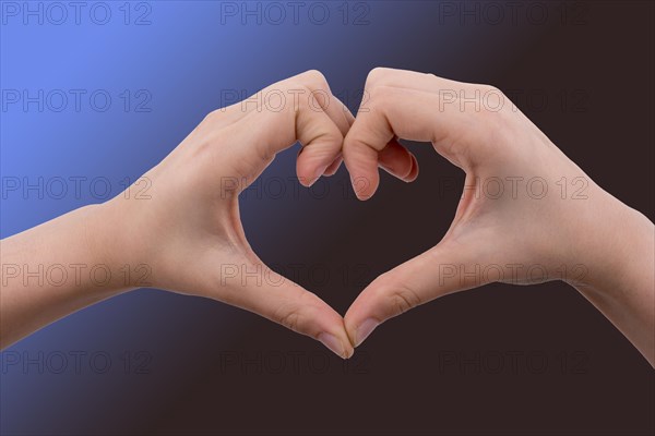 Hand making a heart shape on a white background