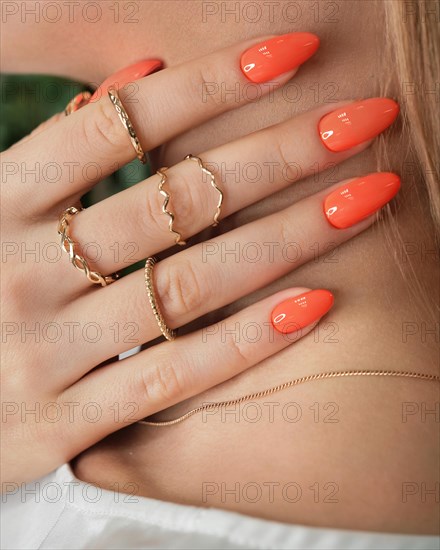 Bright neon manicure on female hands with accessories. Nail design. Beauty hands