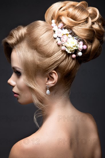 Portrait of a beautiful blond woman in the image of the bride. Picture taken in the studio on a black background. Beauty face and Hairstyle