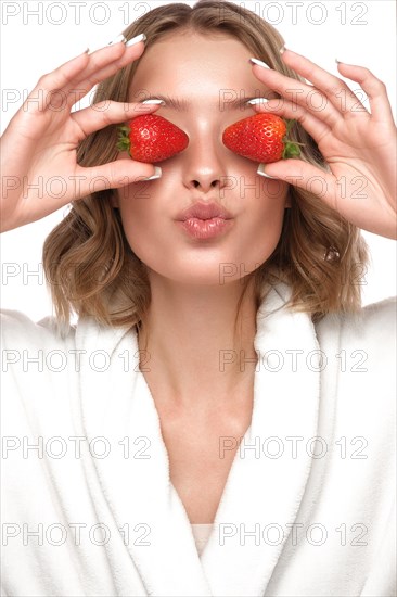 Beautiful tender young girl in a white coat with clean fresh skin posing in front of the camera. Beauty face. Skin care. Photo taken in studio on a white isolate background