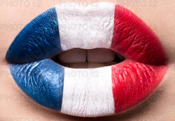 Female lips close up with a picture of the flag of France. Blue