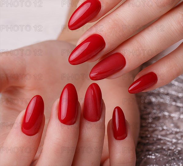 Bright festive red manicure on female hands. Nails design