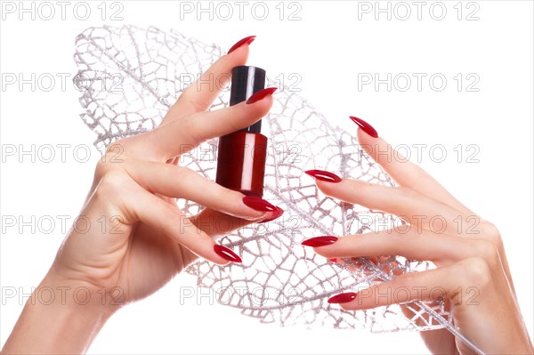 Bright festive red manicure on female hands. Nails design