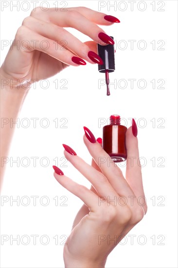 Bright festive red manicure on female hands. Nails design