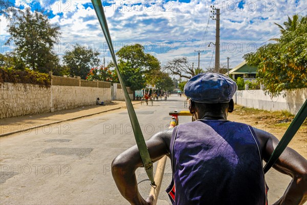 Man pulling a walking rickshaw