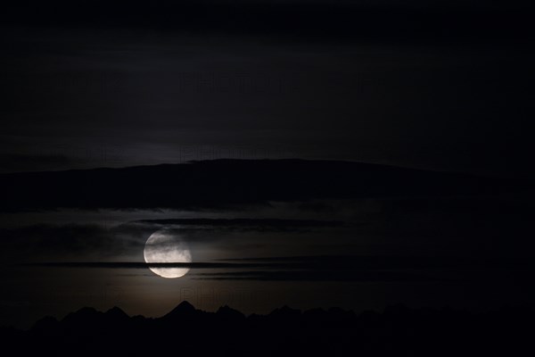 Full moon with cloudy sky and Lechtaler Alps