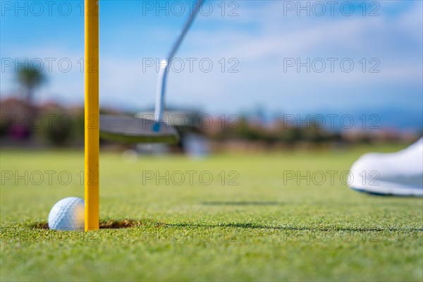 Detail of a man playing golf