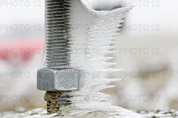 Hoarfrost and ice on a threaded screw
