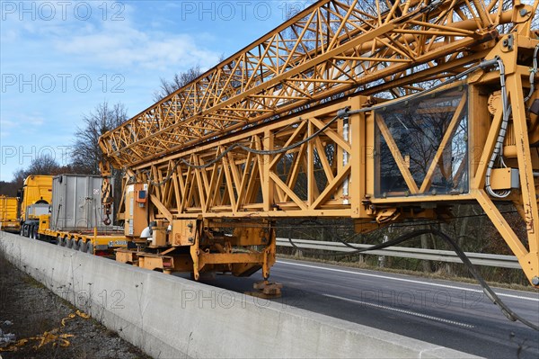 Construction crane and low loader at a building site