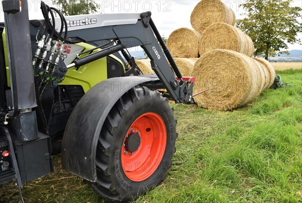 Tractor with bale fork stacking round bales