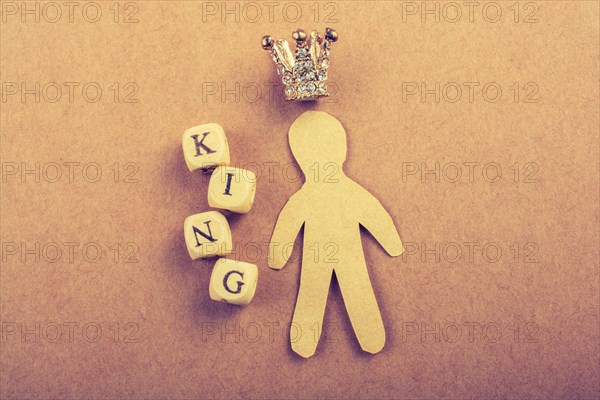 Tiny model crown beside the king wording on brown