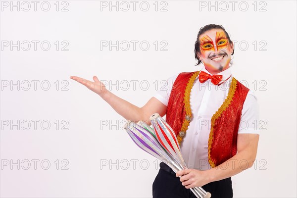 Portrait of a smiling juggler performing juggling with maces isolated on white background
