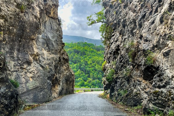 Narrow road Country road without markings through narrow rocky passage in mountainous landscape in southern France