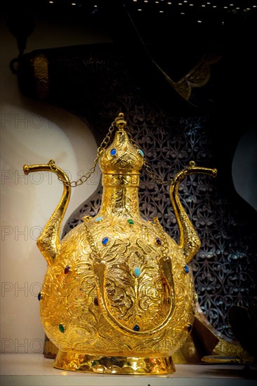 Ancient metal jug in oriental style in antique market