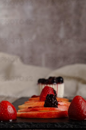 Fresh red apples with drops of water on a slice of wood